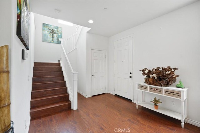 entrance foyer with stairs, recessed lighting, baseboards, and wood finished floors