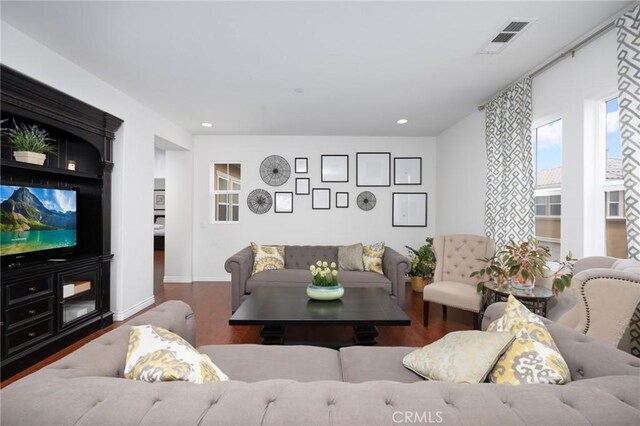 living room featuring baseboards, recessed lighting, wood finished floors, and visible vents