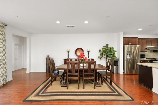 dining area featuring dark wood-style flooring, baseboards, visible vents, and recessed lighting