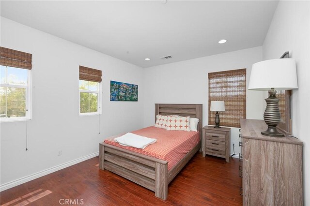 bedroom with recessed lighting, baseboards, visible vents, and wood finished floors
