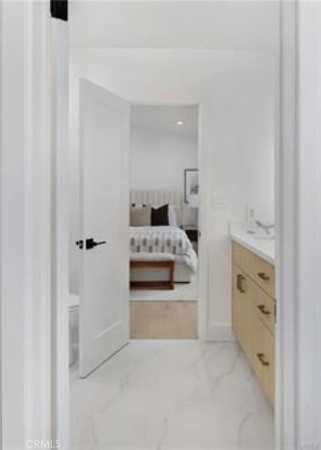 bathroom with vanity and marble finish floor