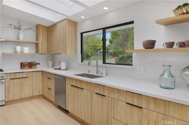 kitchen with open shelves, a sink, light brown cabinets, a skylight, and modern cabinets