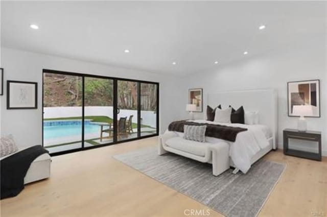 bedroom with light wood-style floors, access to outside, and recessed lighting