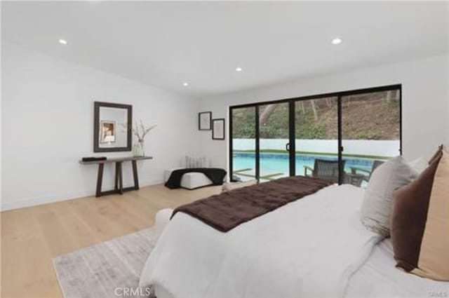 bedroom with baseboards, recessed lighting, wood finished floors, and access to exterior