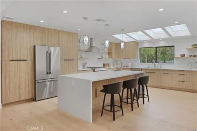 kitchen featuring light brown cabinetry, modern cabinets, open shelves, and high quality fridge