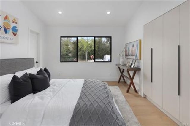 bedroom with recessed lighting and light wood-style floors