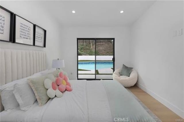 bedroom featuring baseboards, recessed lighting, and wood finished floors