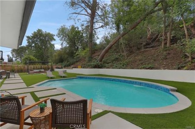 view of swimming pool featuring a fenced in pool and a patio area