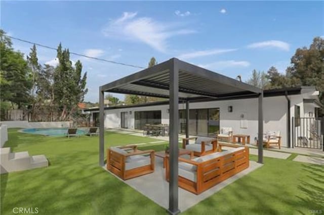 back of property featuring a patio area, an outdoor pool, fence, and a yard