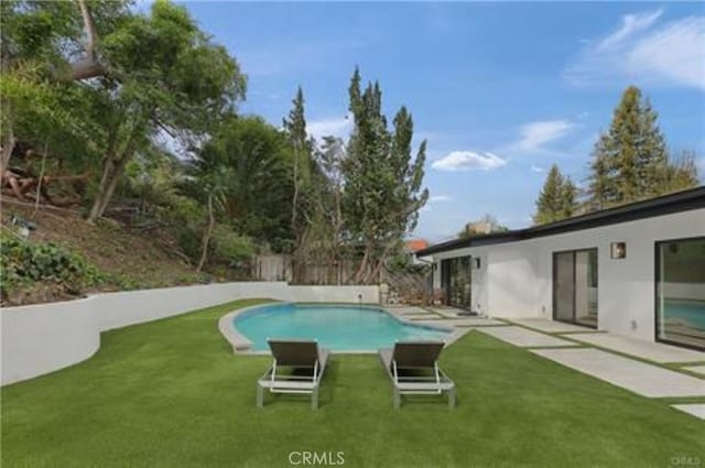 view of pool featuring a fenced in pool, a patio area, and a yard