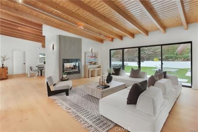 living area featuring wood ceiling, lofted ceiling with beams, and wood finished floors