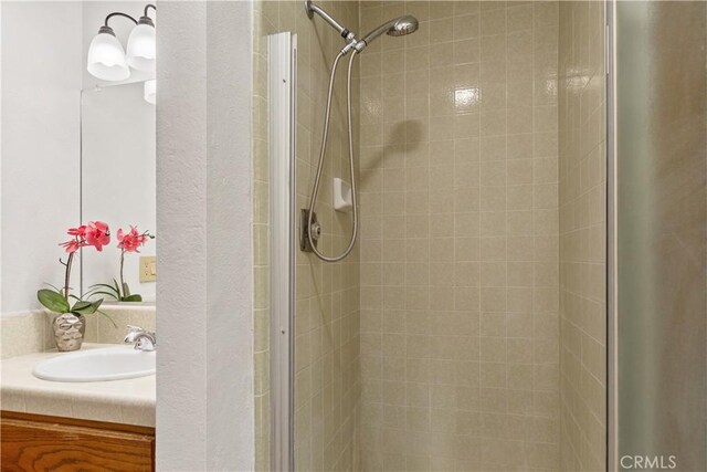 bathroom featuring vanity and a shower stall
