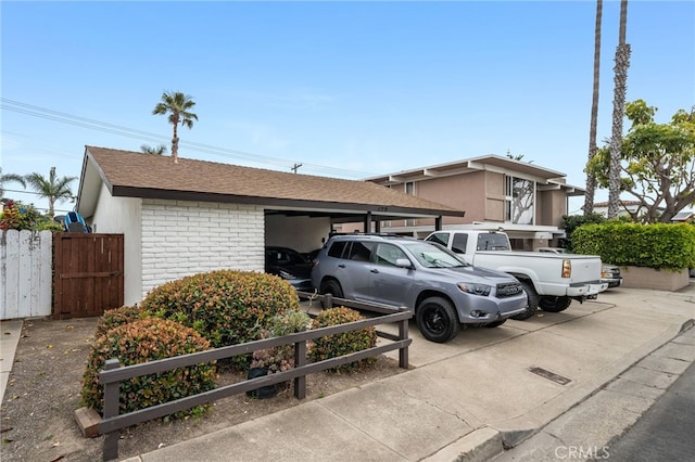 129 Avenida Rosa, San Clemente, CA 92672 - exterior space featuring fence, roof with shingles, brick siding, stucco siding, and uncovered parking
