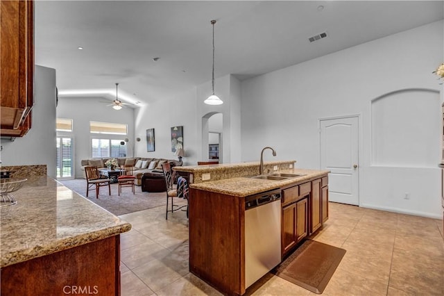 kitchen featuring a sink, arched walkways, a ceiling fan, stainless steel dishwasher, and visible vents