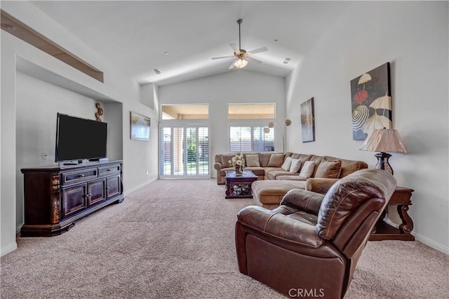 carpeted living room with ceiling fan, baseboards, and high vaulted ceiling