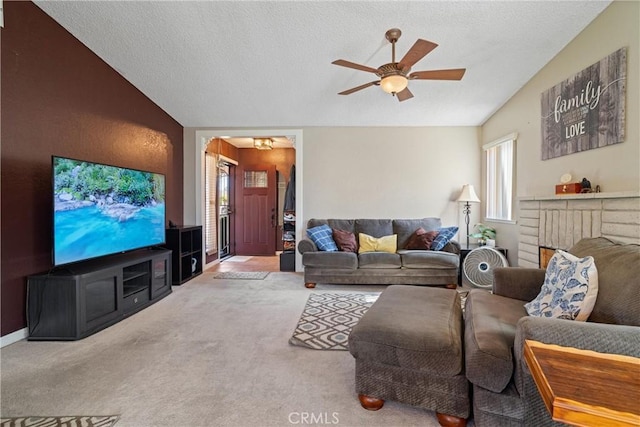 living area featuring a wealth of natural light, a ceiling fan, and lofted ceiling