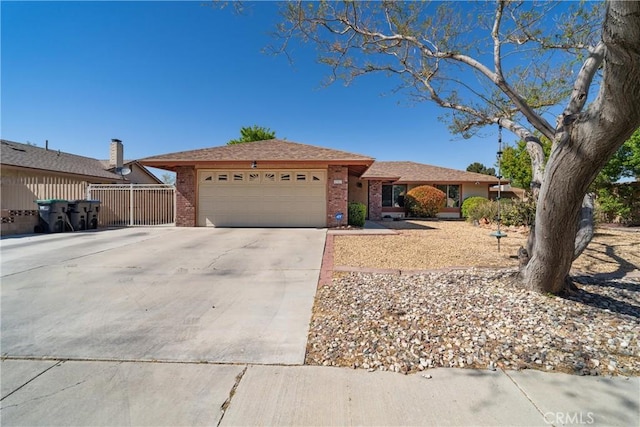 single story home with an attached garage, fence, driveway, and brick siding