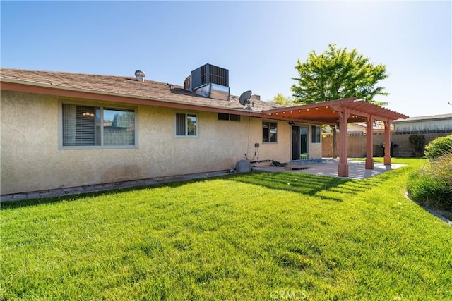 back of house featuring fence, a pergola, a patio, stucco siding, and a lawn