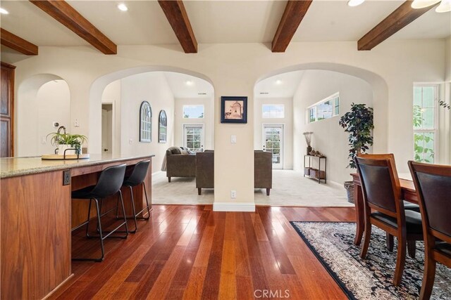 interior space featuring beamed ceiling, recessed lighting, baseboards, and dark wood-style floors