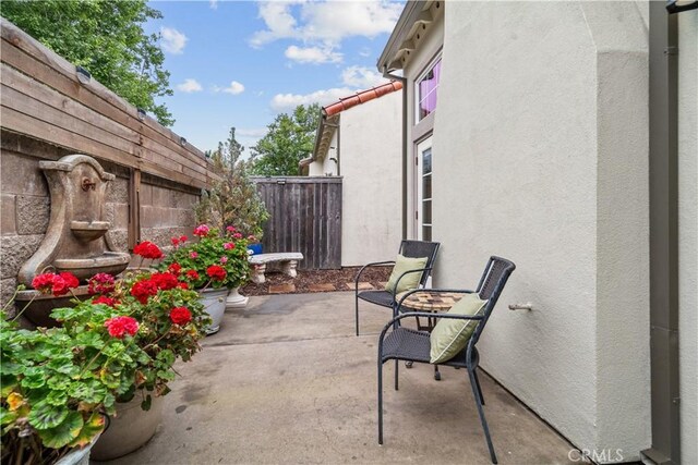 view of patio / terrace featuring fence