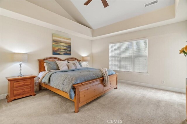 carpeted bedroom featuring visible vents, baseboards, ceiling fan, and vaulted ceiling
