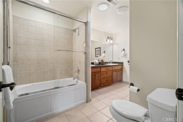 bathroom featuring visible vents, vanity, toilet, tile patterned floors, and enclosed tub / shower combo