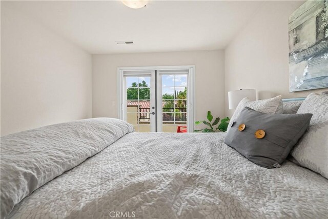 bedroom featuring visible vents and access to exterior