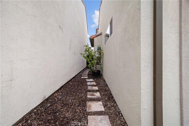 view of side of home with stucco siding