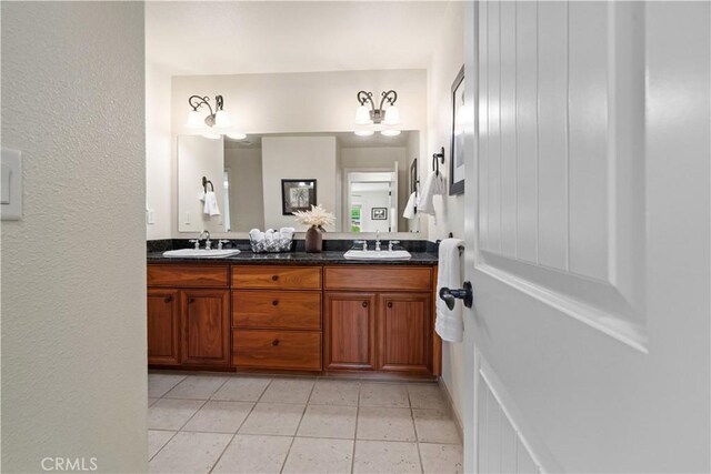 bathroom featuring double vanity, a sink, and tile patterned flooring