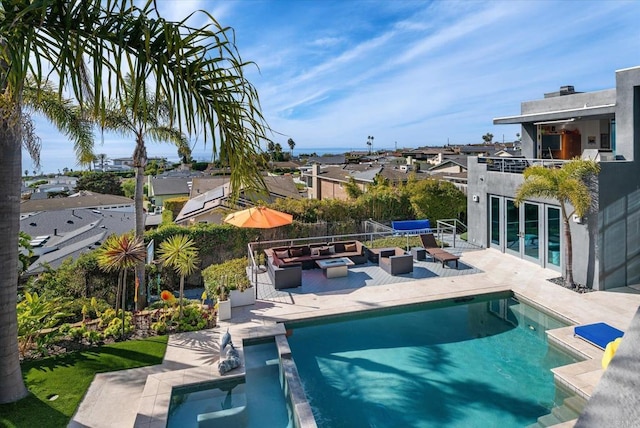 view of pool featuring an outdoor hangout area, a pool with connected hot tub, a patio area, and a residential view