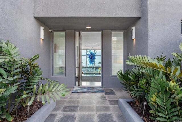 entrance to property featuring stucco siding