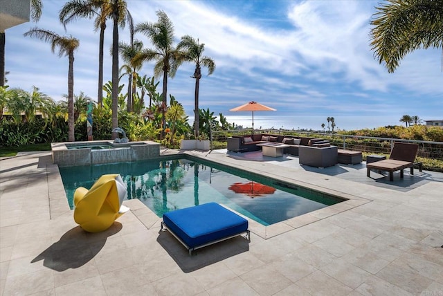 view of swimming pool featuring an outdoor hangout area, a pool with connected hot tub, and a patio area