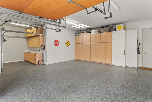 garage featuring baseboards and a garage door opener
