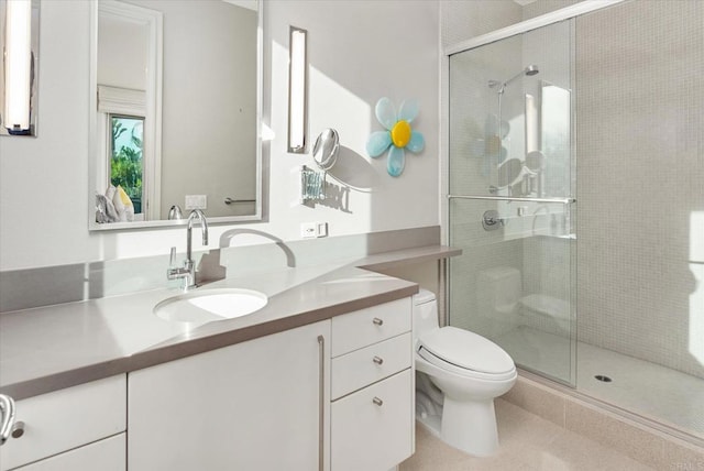 bathroom featuring vanity, tile patterned flooring, a stall shower, and toilet
