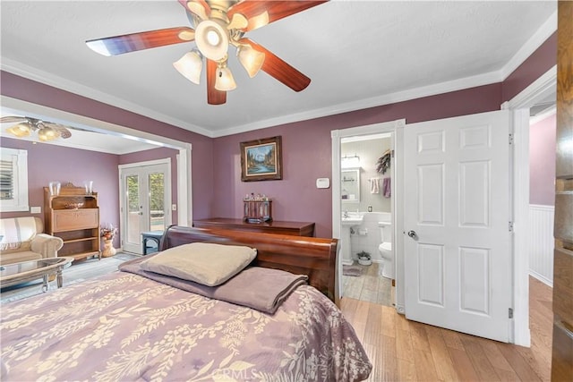 bedroom with ornamental molding, ensuite bathroom, access to outside, french doors, and light wood-style flooring