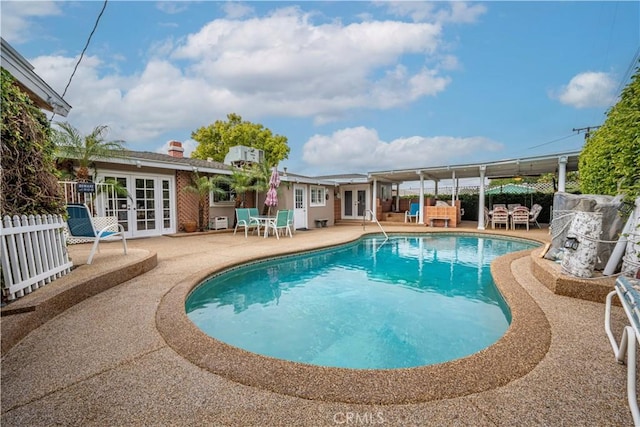 pool featuring french doors, a patio, and a fenced backyard