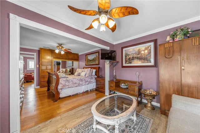 bedroom with crown molding, light wood-style flooring, ceiling fan, and baseboards