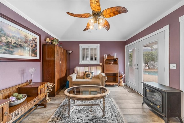 living area featuring ceiling fan, ornamental molding, french doors, and wood finished floors
