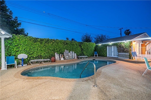 view of pool with a fenced in pool, a patio area, and french doors