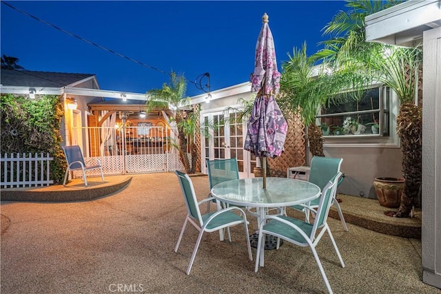 patio at twilight featuring outdoor dining space