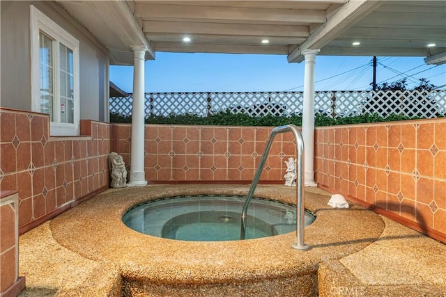 view of swimming pool with an in ground hot tub, fence, and a sink