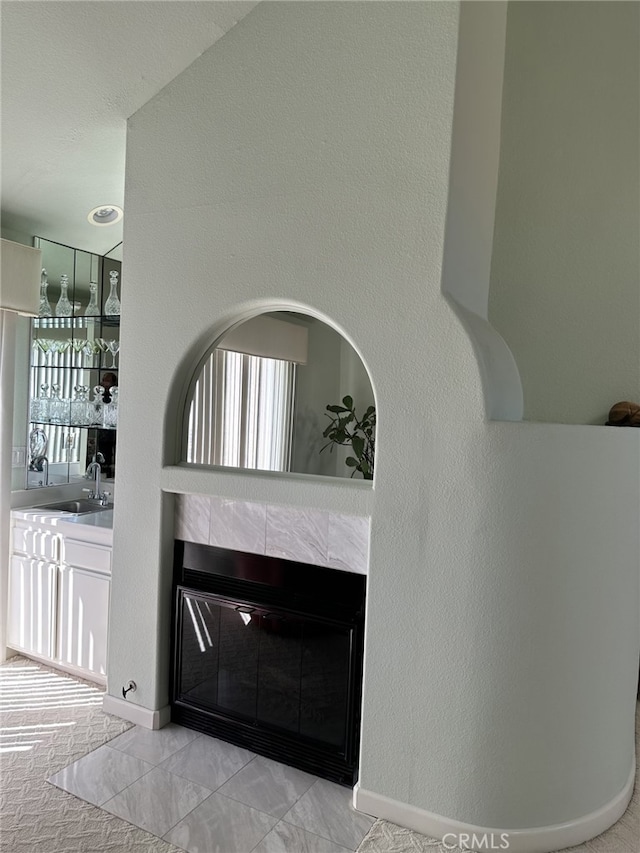 17 Marseille, Laguna Niguel, CA 92677 - details featuring baseboards, a tiled fireplace, and a sink
