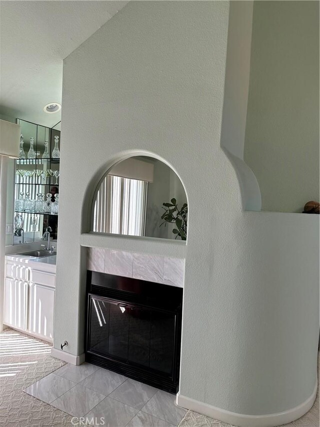 17 Marseille, Laguna Niguel, CA 92677 - interior details with a tiled fireplace, a sink, baseboards, and a textured wall