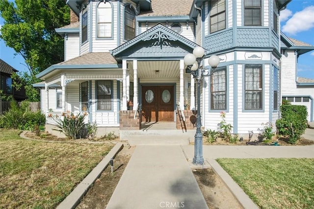 3716 Viader Dr, Modesto, CA 95356 - property entrance with covered porch, a lawn, and a shingled roof