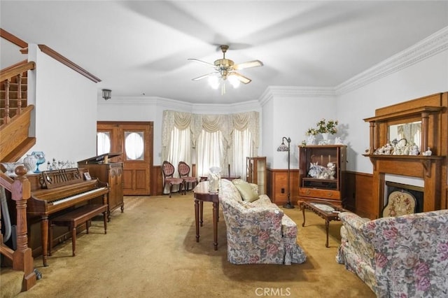 3716 Viader Dr, Modesto, CA 95356 - carpeted living area with ceiling fan, a wainscoted wall, ornamental molding, stairway, and a fireplace