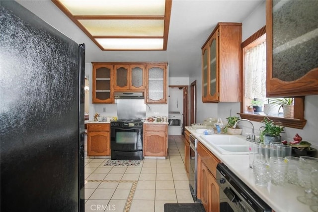 3716 Viader Dr, Modesto, CA 95356 - kitchen featuring black appliances, a sink, light tile patterned floors, and brown cabinetry