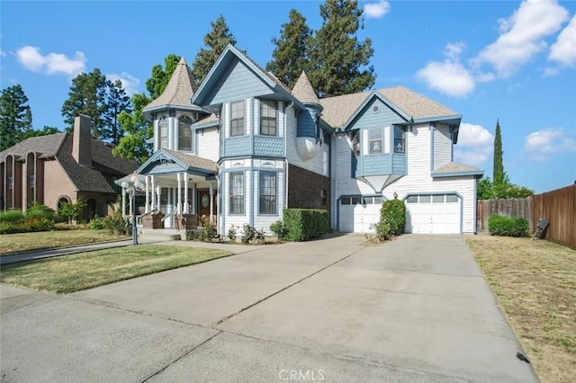 3716 Viader Dr, Modesto, CA 95356 - victorian home featuring an attached garage, concrete driveway, and a porch