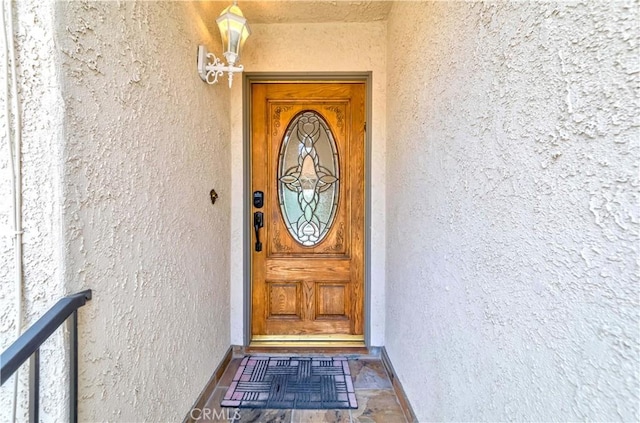11449 Tampa Ave Unit 139, Porter Ranch, CA 91326 - doorway to property with stucco siding
