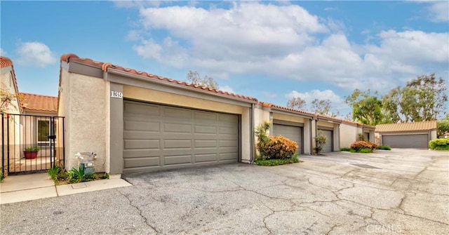 11449 Tampa Ave Unit 139, Porter Ranch, CA 91326 - view of front of home with a tiled roof and stucco siding