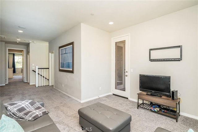 carpeted living room with recessed lighting and baseboards